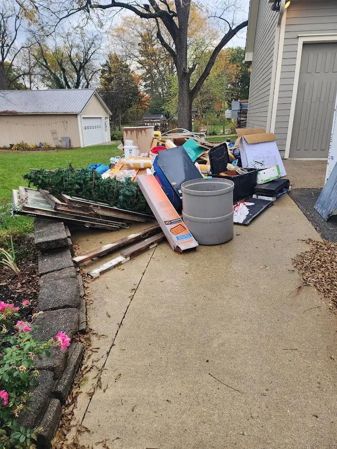 Dumpster being loaded with debris for Commercial Dumpster Rental in Batesville